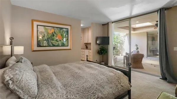 a bedroom with a bed and a painting on the wall