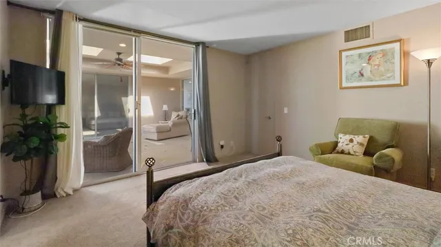 a bedroom with a bed and a television