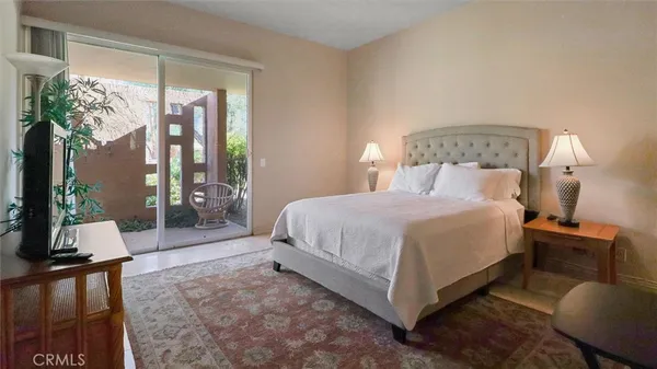 a bedroom with a bed and large mirror