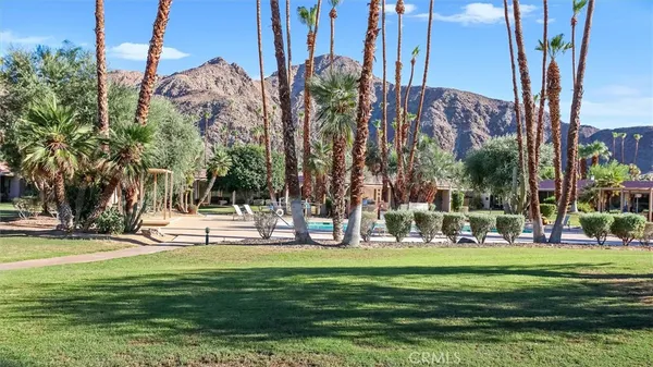 a building view with a garden and trees
