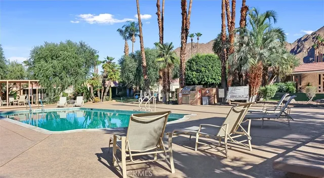 a view of a swimming pool with lounge chairs