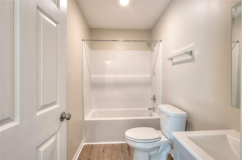 407 Wall Street Monroe, GA 30655 - Photo 25 of 51 a bathroom with a toilet and a bathtub