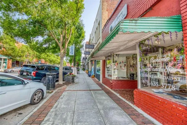 a view of a chairs and tables in the back yard of the house