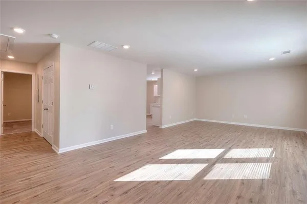 a view of an empty room and wooden floor