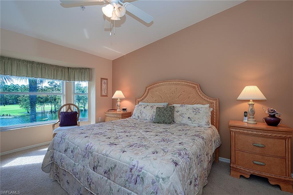 8640 Cedar Hammock Circle, Unit 523 Naples, FL 34112 - Photo 15 of 29 a bedroom with a bed and a large window