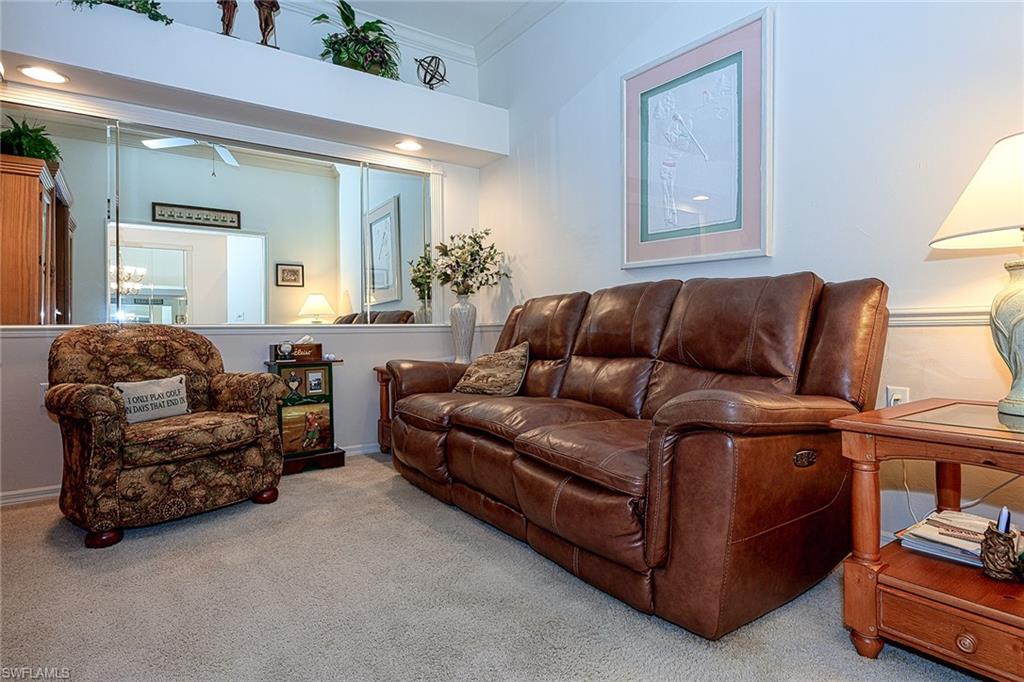 8640 Cedar Hammock Circle, Unit 523 Naples, FL 34112 - Photo 17 of 29 a living room with furniture and a couch