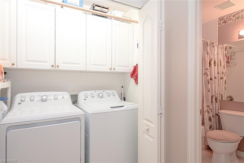 8640 Cedar Hammock Circle, Unit 523 Naples, FL 34112 - Photo 18 of 29 a utility room with dryer and washer