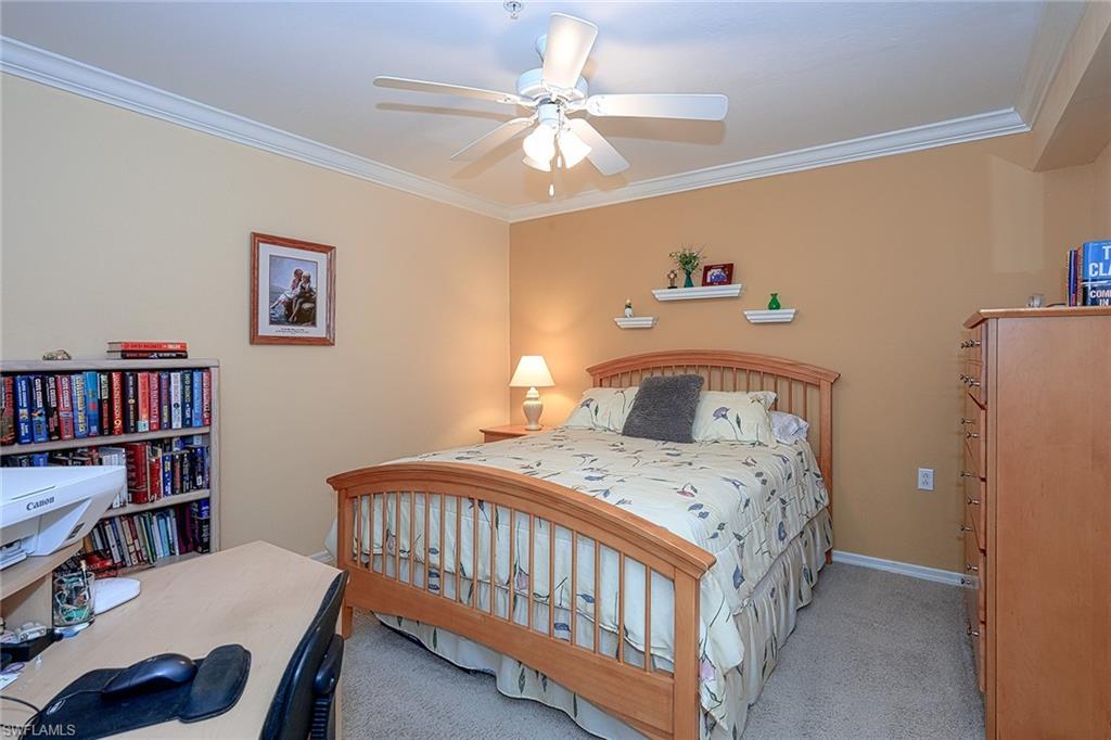 8640 Cedar Hammock Circle, Unit 523 Naples, FL 34112 - Photo 19 of 29 a bedroom with a bed and a book shelf