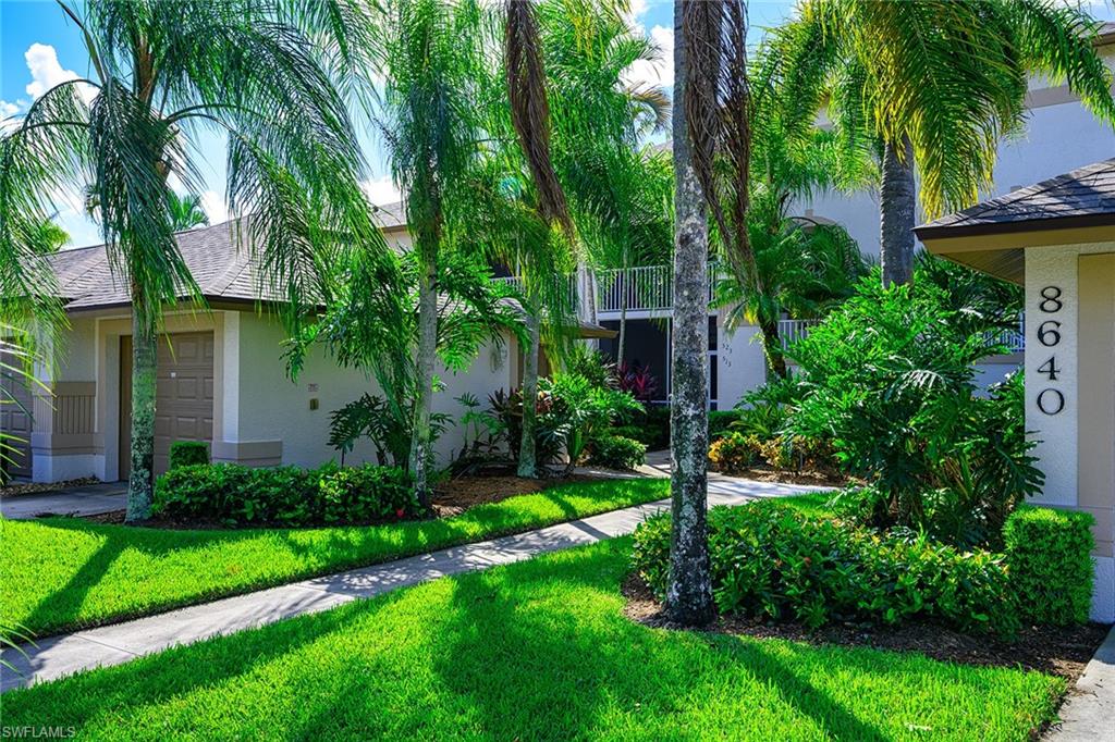 8640 Cedar Hammock Circle, Unit 523 Naples, FL 34112 - Photo 2 of 29 a view of a house with a tree and plants