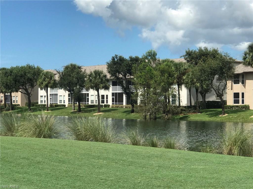 8640 Cedar Hammock Circle, Unit 523 Naples, FL 34112 - Photo 24 of 29 a view of a lake with a building in the background