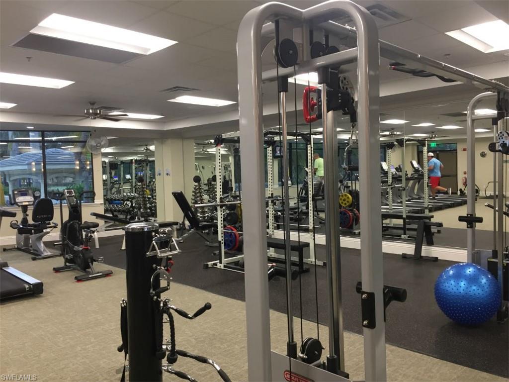 8640 Cedar Hammock Circle, Unit 523 Naples, FL 34112 - Photo 26 of 29 a view of a room with gym equipment