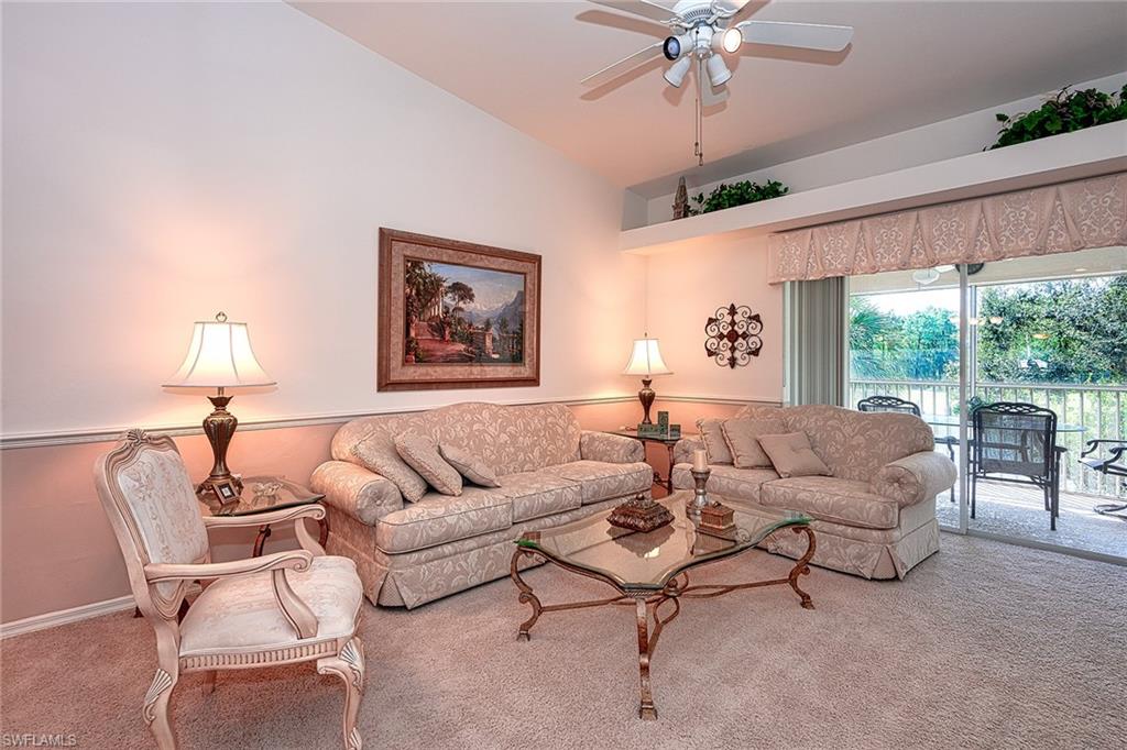 8640 Cedar Hammock Circle, Unit 523 Naples, FL 34112 - Photo 6 of 29 a living room with furniture and a large window