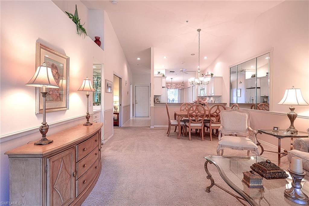 8640 Cedar Hammock Circle, Unit 523 Naples, FL 34112 - Photo 7 of 29 a kitchen with stainless steel appliances kitchen island granite countertop a sink and cabinets
