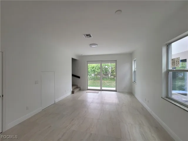 a bathroom with a granite countertop sink and a toilet
