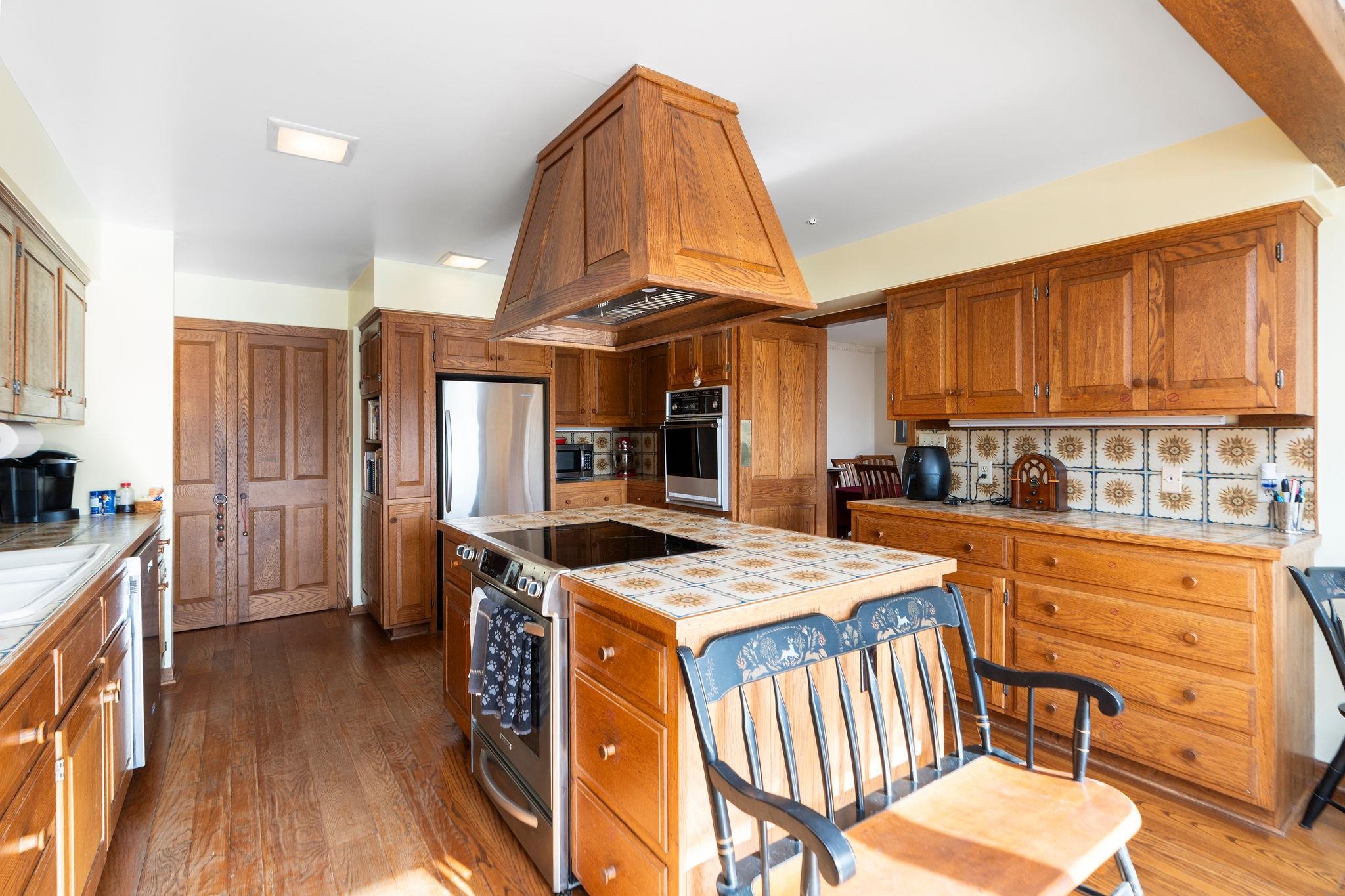 129 Shemariah Road Middlebrook, VA 24459 - Photo 16 of 75 a open kitchen with stainless steel appliances granite countertop a stove a refrigerator a sink dishwasher and a dining table with wooden floor