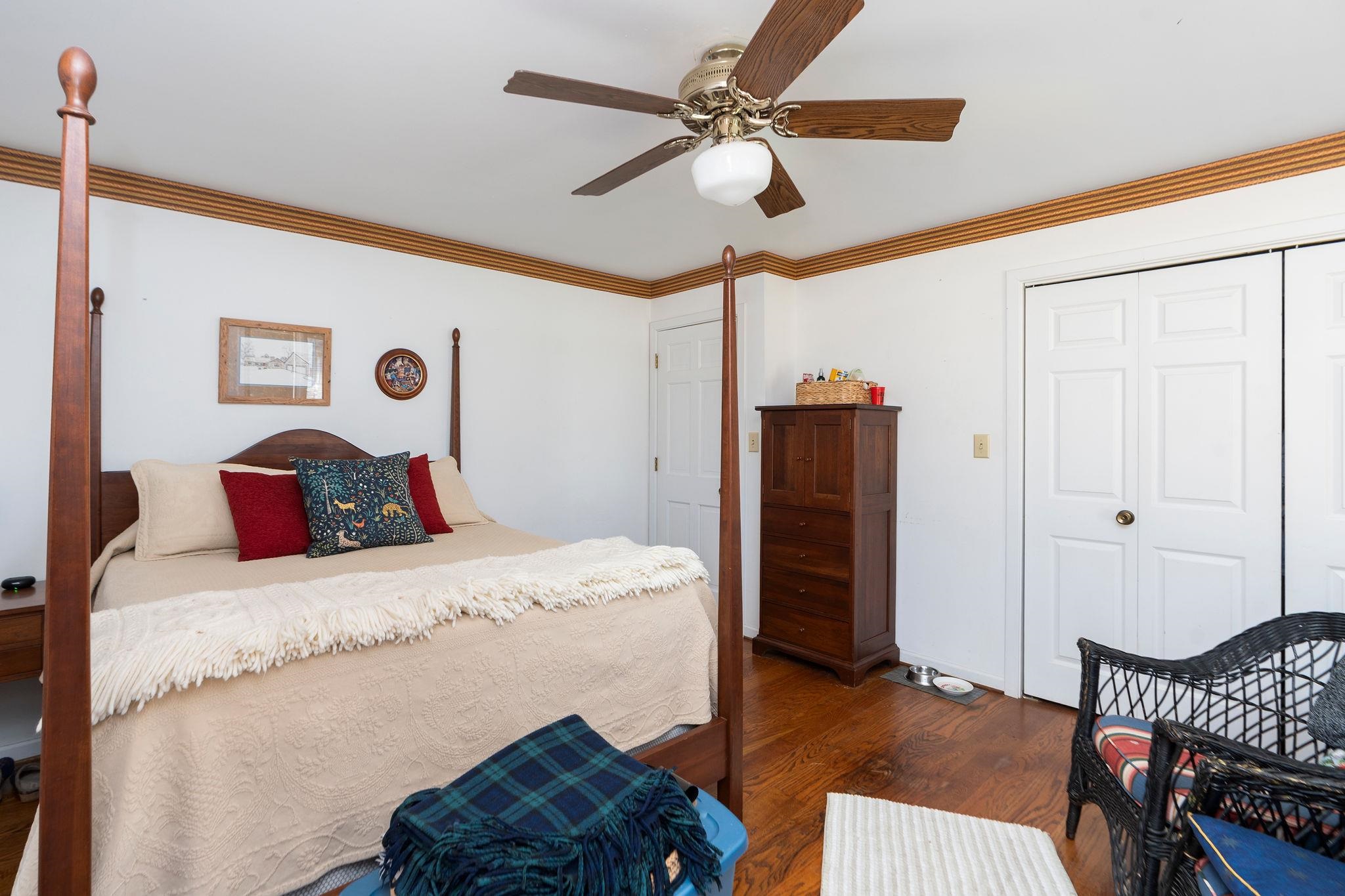 129 Shemariah Road Middlebrook, VA 24459 - Photo 29 of 75 a bedroom with a bed and a chandelier