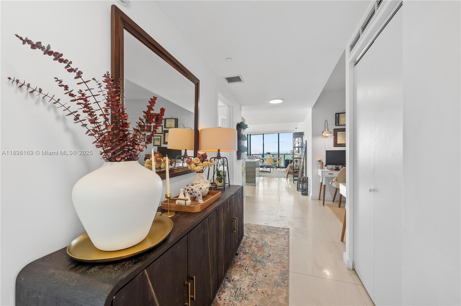 460 Northeast 28th Street, Unit 1901 Miami, FL 33137 - Photo 11 of 34 an entryway dining room with furniture and wooden floor