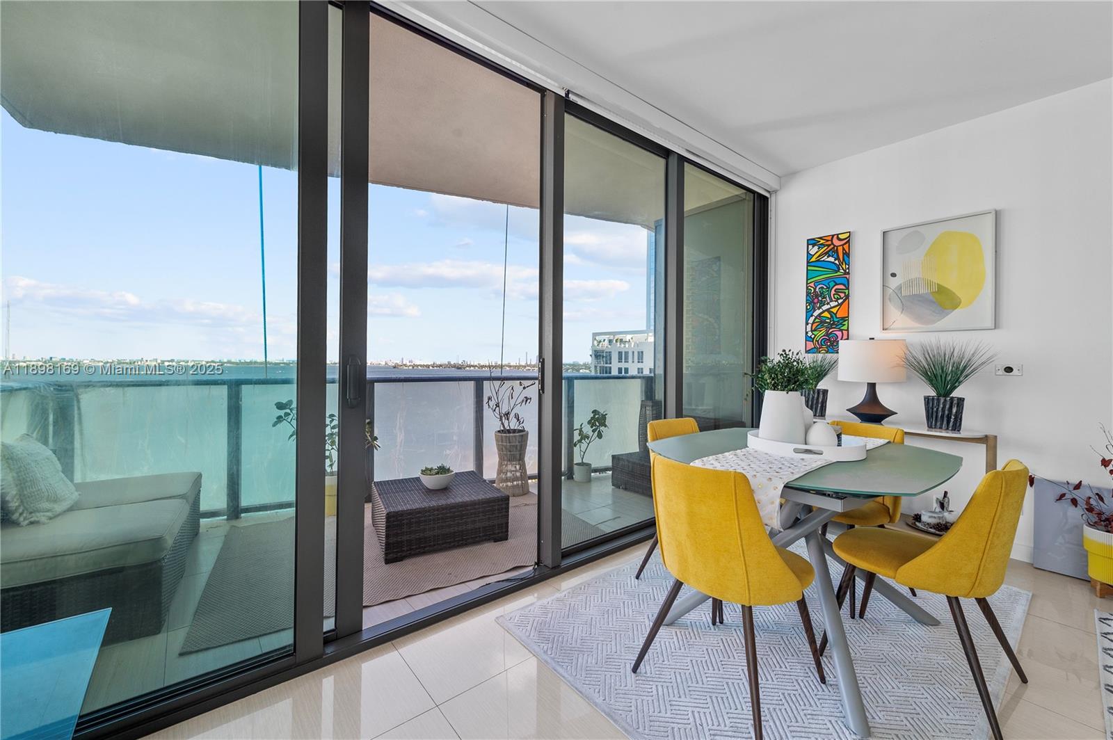 460 Northeast 28th Street, Unit 1901 Miami, FL 33137 - Photo 25 of 34 a dining room with furniture and a floor to ceiling window