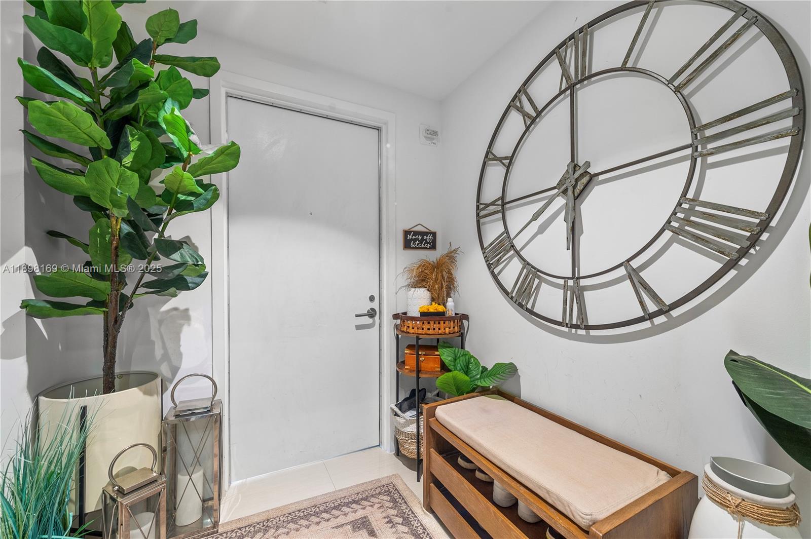 460 Northeast 28th Street, Unit 1901 Miami, FL 33137 - Photo 29 of 34 a living room with furniture a chandelier and a potted plant