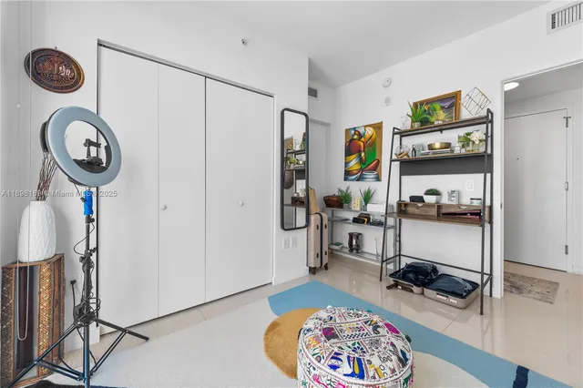 a view of a hallway with workspace and entryway with wooden floor
