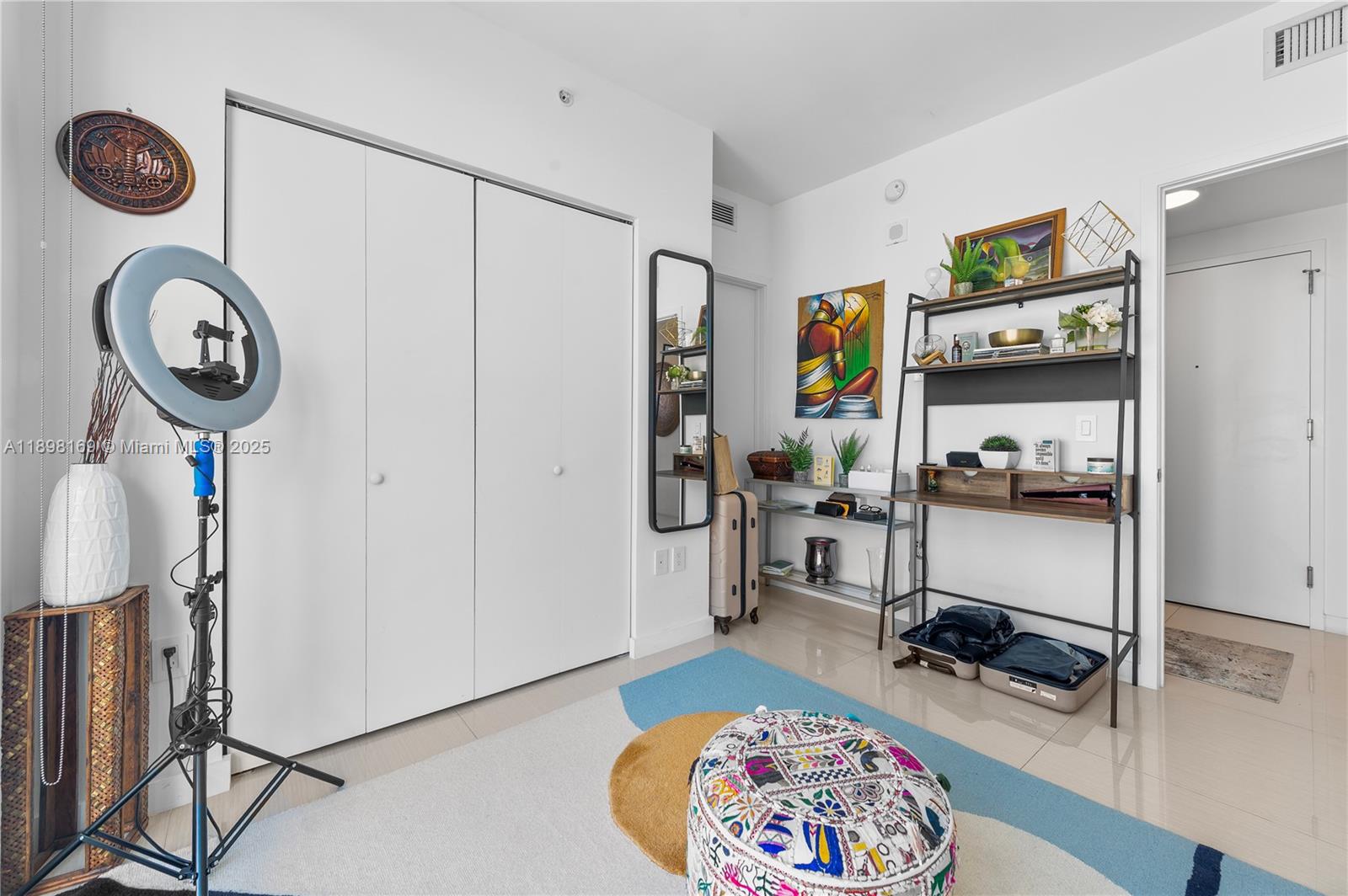 460 Northeast 28th Street, Unit 1901 Miami, FL 33137 - Photo 3 of 34 a view of a hallway with workspace and entryway with wooden floor
