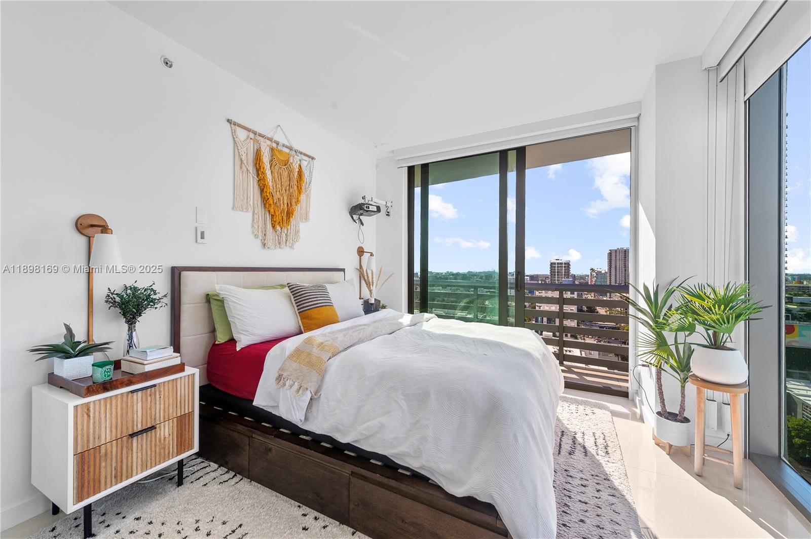 460 Northeast 28th Street, Unit 1901 Miami, FL 33137 - Photo 7 of 34 a bedroom with a bed and a large window