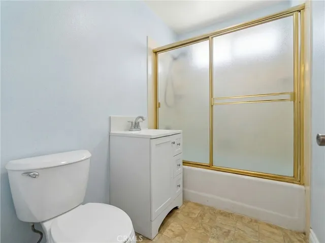 a white toilet sitting next to a bathroom sink