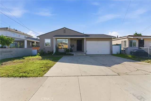 a front view of a house with a garden and yard