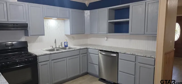 a kitchen with a sink and cabinets