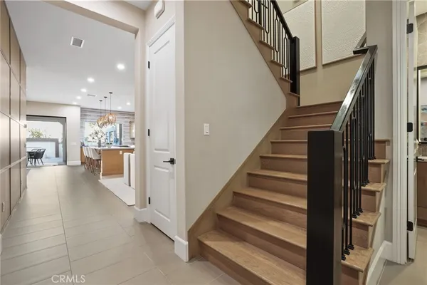 a spacious bedroom with a bed and a chandelier