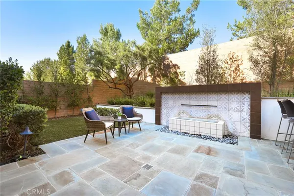 a view of a house with backyard sitting area and garden