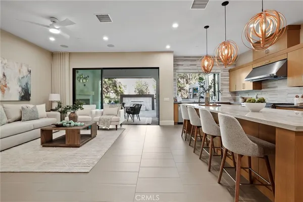 a living room with couches a dining table kitchen view and living room view