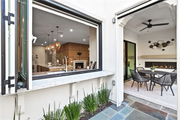 a view of a patio with couches table and chairs and potted plants