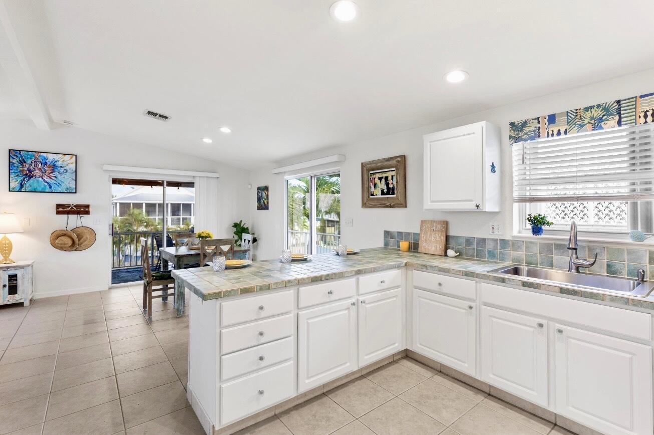 157 Mars Lane Key West, FL 33040 - Photo 19 of 41 a kitchen with a sink window and cabinets