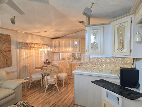 a kitchen with stainless steel appliances granite countertop a sink and a refrigerator