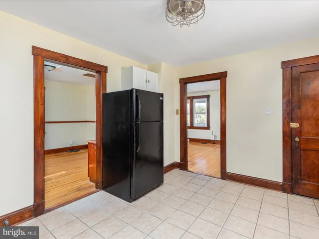 a kitchen with a refrigerator and cabinets