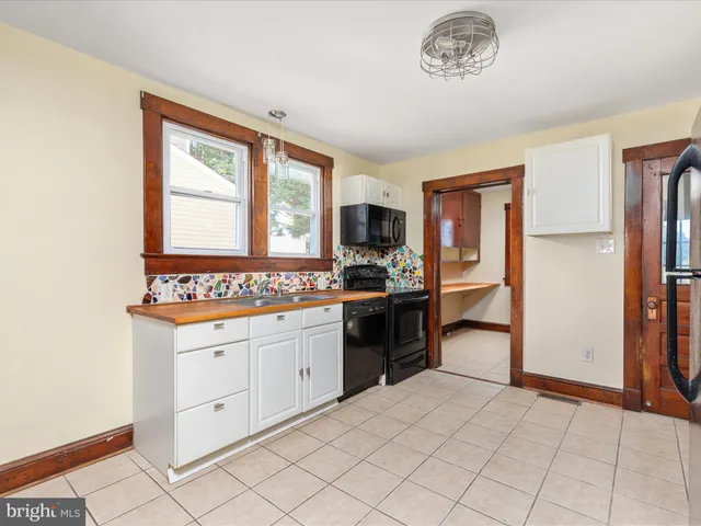 a view of a kitchen with kitchen island and windows