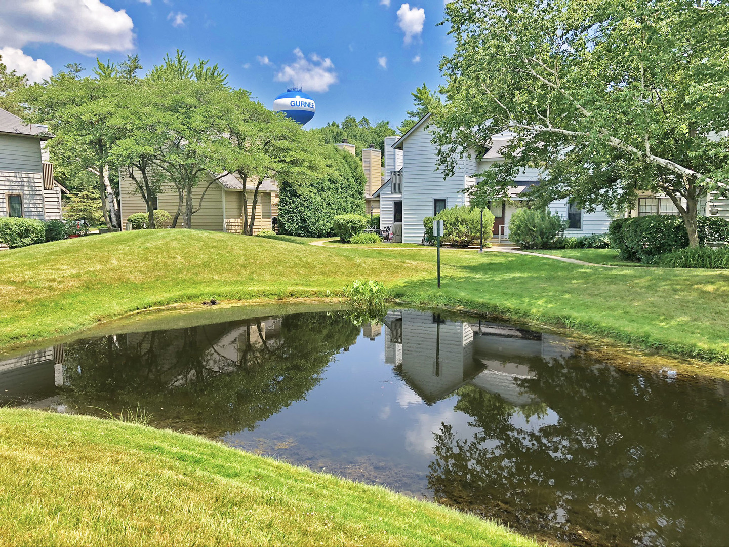 749 Shepard Court Gurnee, IL 60031 - Photo 2 of 22 a swimming pool with outdoor space and trees in the background