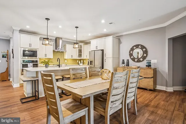 a bedroom with a bed and a flat tv screen on dresser