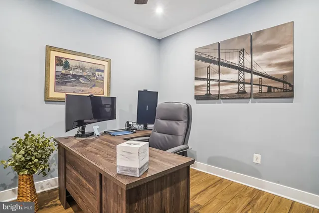 a view of a living room and kitchen with furniture and a large window
