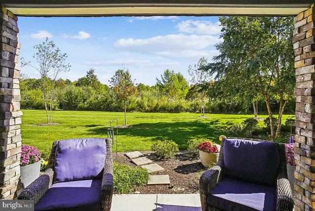 a view of a big building with a big yard and large trees
