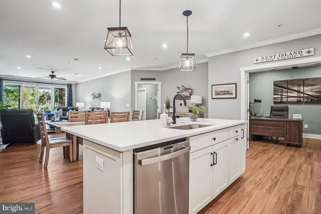 a living room with furniture large window and wooden floor