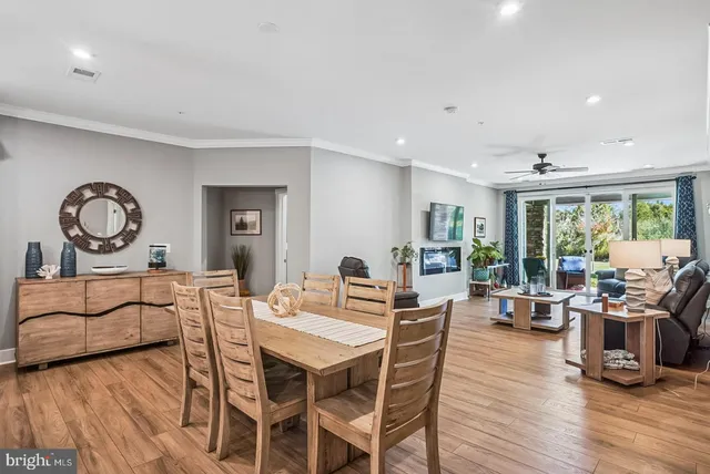 a living room with furniture a flat screen tv and a chandelier
