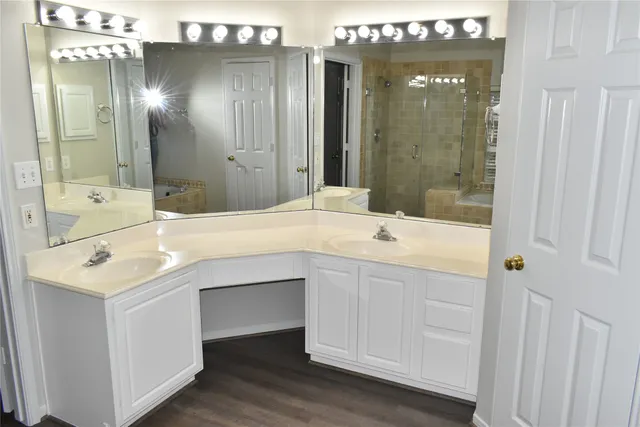 a bathroom with a sink double vanity and a mirror