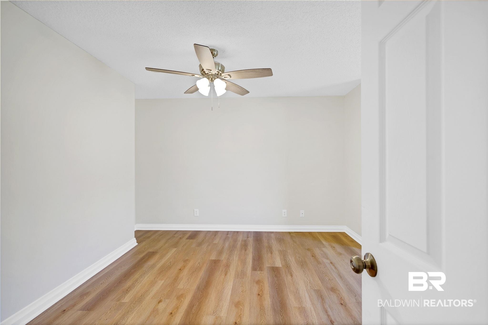 11964 Stroh Road Daphne, AL 36527 - Photo 26 of 58 Empty room with a textured ceiling, baseboards, a ceiling fan, and wood finished floors