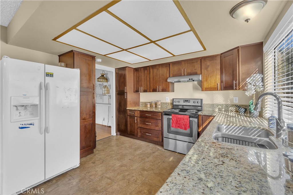 4422 East Silverleaf Avenue Orange, CA 92869 - Photo 10 of 27 a kitchen with stainless steel appliances granite countertop a refrigerator and a sink