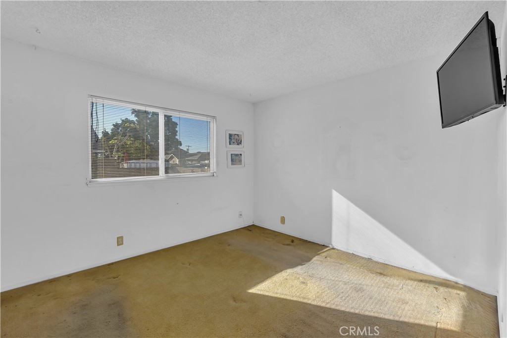 4422 East Silverleaf Avenue Orange, CA 92869 - Photo 15 of 27 a view of a room with wooden floor and screen tv