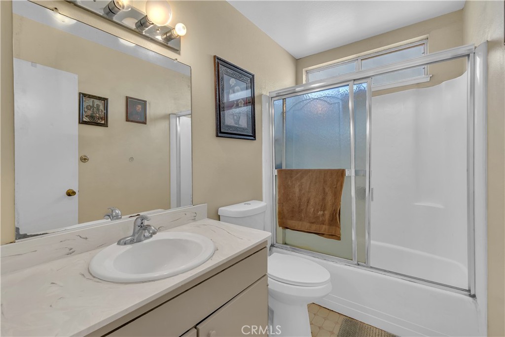 4422 East Silverleaf Avenue Orange, CA 92869 - Photo 19 of 27 a bathroom with a granite countertop sink toilet and shower