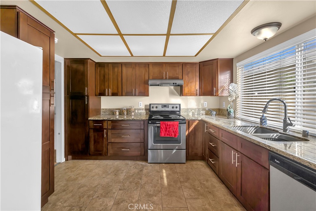 4422 East Silverleaf Avenue Orange, CA 92869 - Photo 7 of 27 a kitchen with granite countertop a sink stainless steel appliances and cabinets