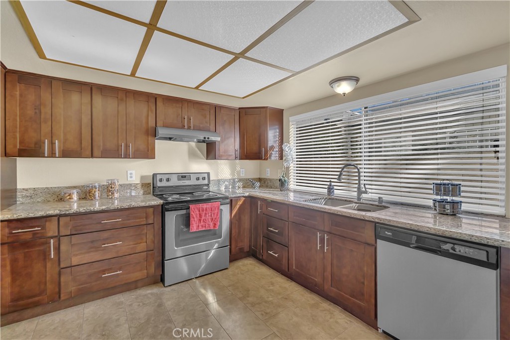 4422 East Silverleaf Avenue Orange, CA 92869 - Photo 8 of 27 a kitchen with granite countertop a sink stove and cabinets